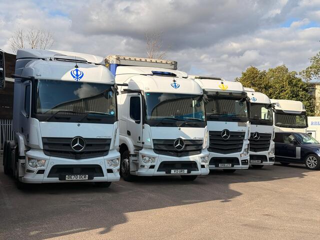 A lineup of URS Choices Mercedes tractor units parked in the yard
